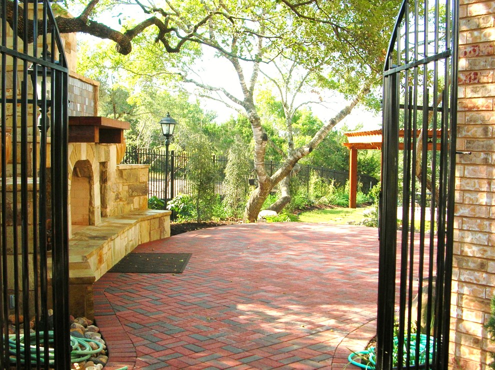 Design ideas for a traditional sloped garden in Austin with a garden path and concrete pavers.