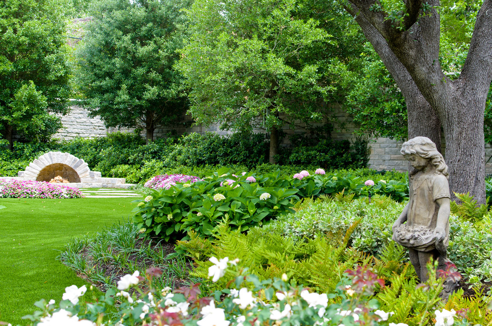 Photo of a traditional garden in Dallas with with fireplace.