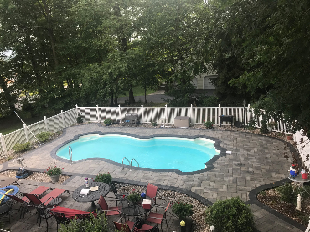 Inspiration for a mid-sized transitional concrete paver pool remodel