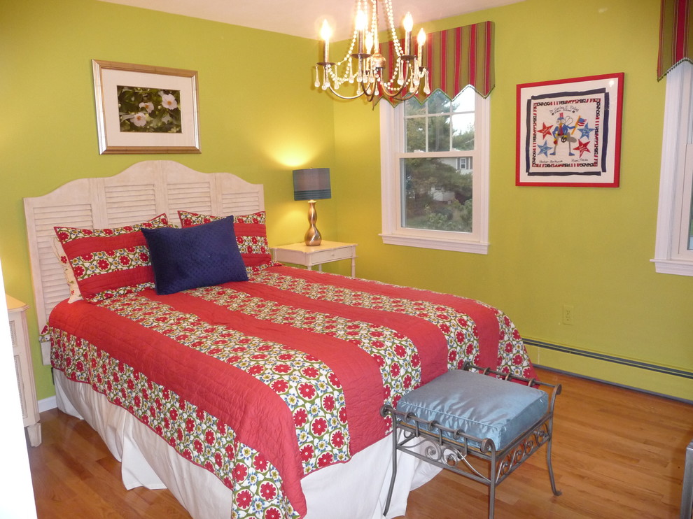 Photo of an eclectic guest bedroom in Boston with green walls and medium hardwood floors.