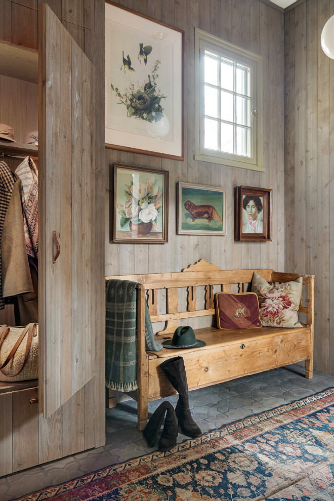 Example of a french country gray floor and wood wall mudroom design in Minneapolis with beige walls