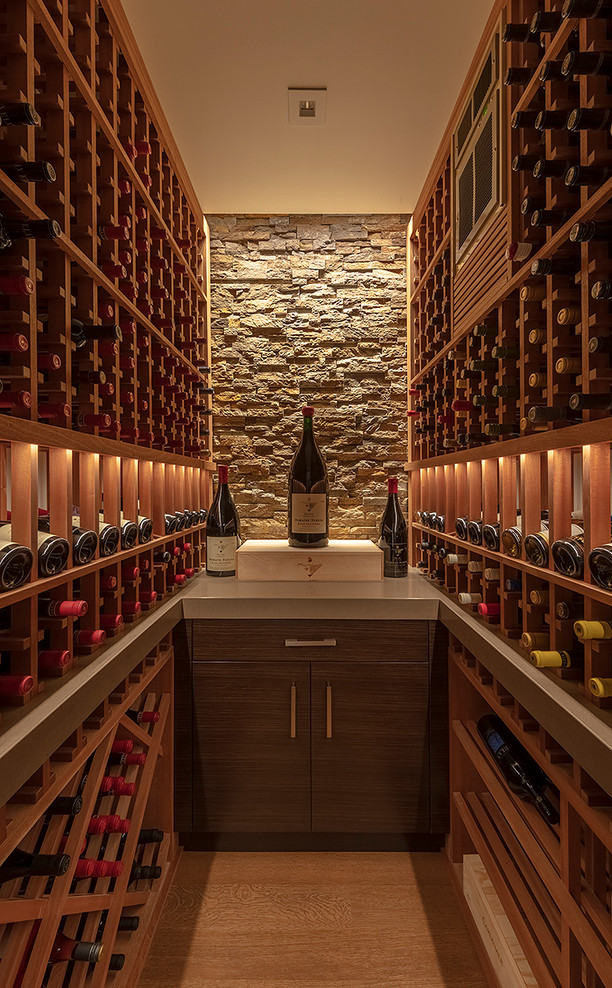 Photo of a contemporary wine cellar in San Francisco with light hardwood floors and storage racks.