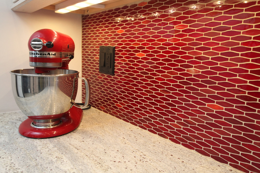 Transitional ceramic tile kitchen photo in New York with an undermount sink, shaker cabinets, light wood cabinets, granite countertops, red backsplash, ceramic backsplash and stainless steel appliances