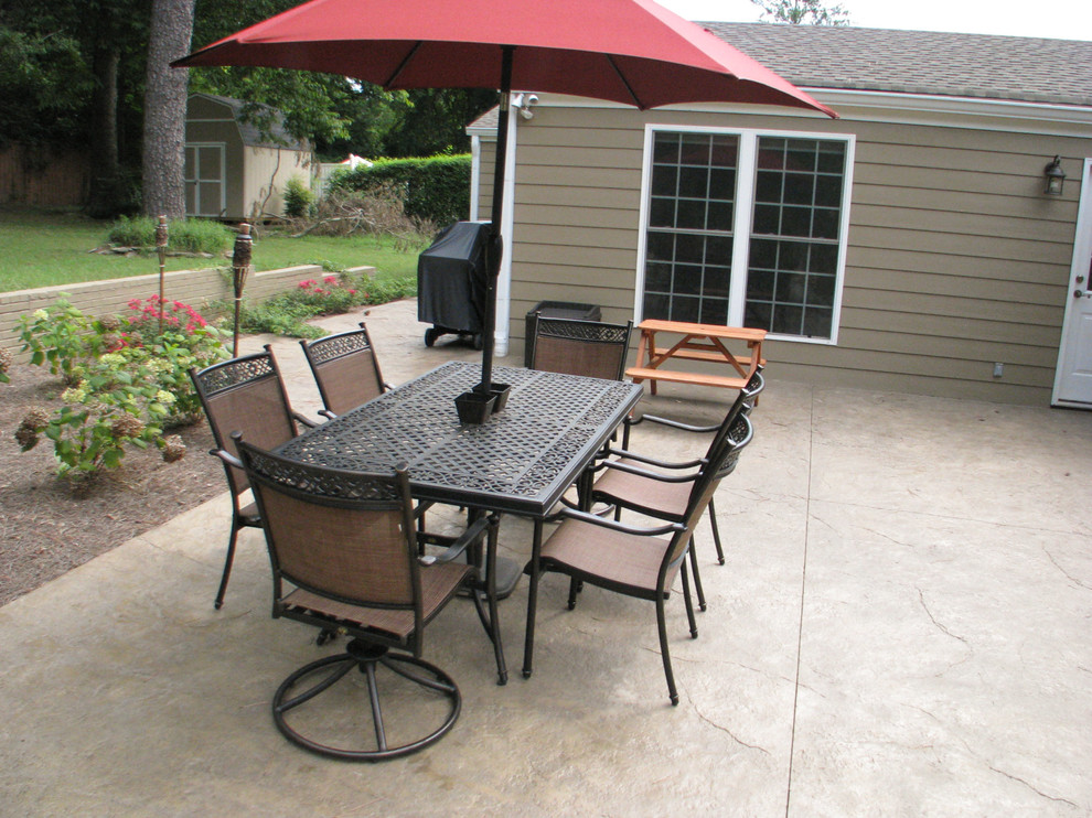 Mid-sized traditional backyard patio in Nashville with stamped concrete and no cover.