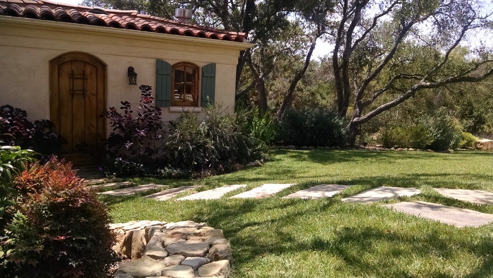 Inspiration for a mediterranean front yard shaded garden in Santa Barbara with natural stone pavers.