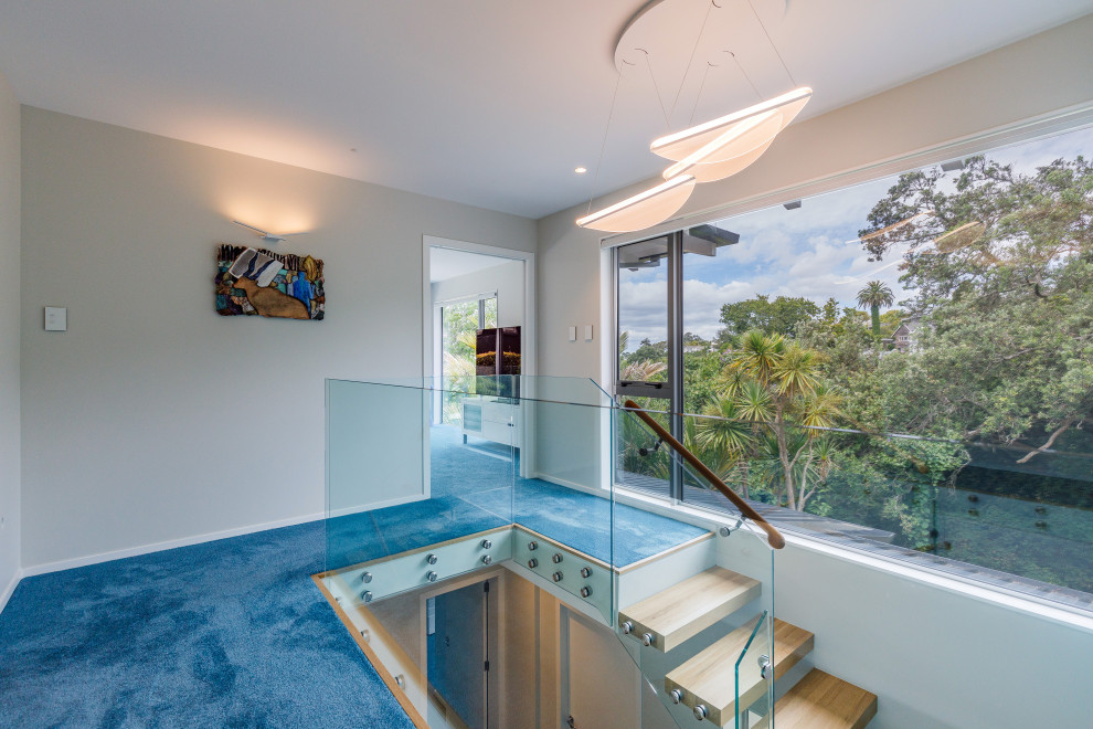 Small contemporary hallway in Auckland with white walls, porcelain floors and blue floor.