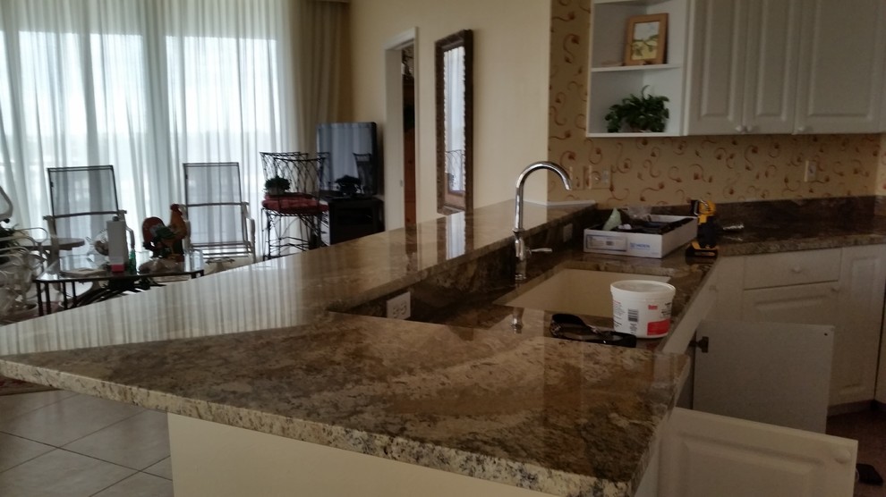 Inspiration for a small transitional u-shaped ceramic tile open concept kitchen remodel in Miami with an undermount sink, raised-panel cabinets, white cabinets, granite countertops, multicolored backsplash, white appliances and a peninsula