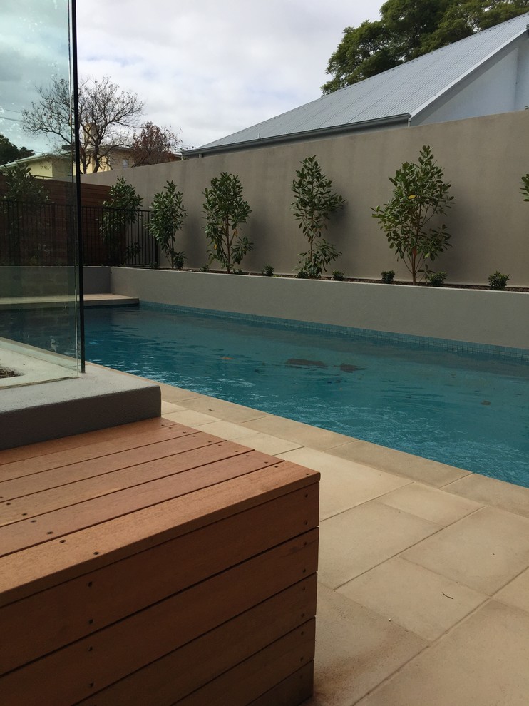 Design ideas for a mid-sized traditional backyard pool in Adelaide with concrete pavers.
