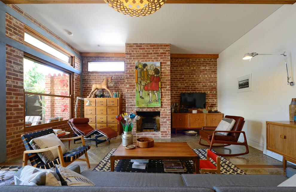 Photo of a midcentury living room in Adelaide with a brick fireplace surround.