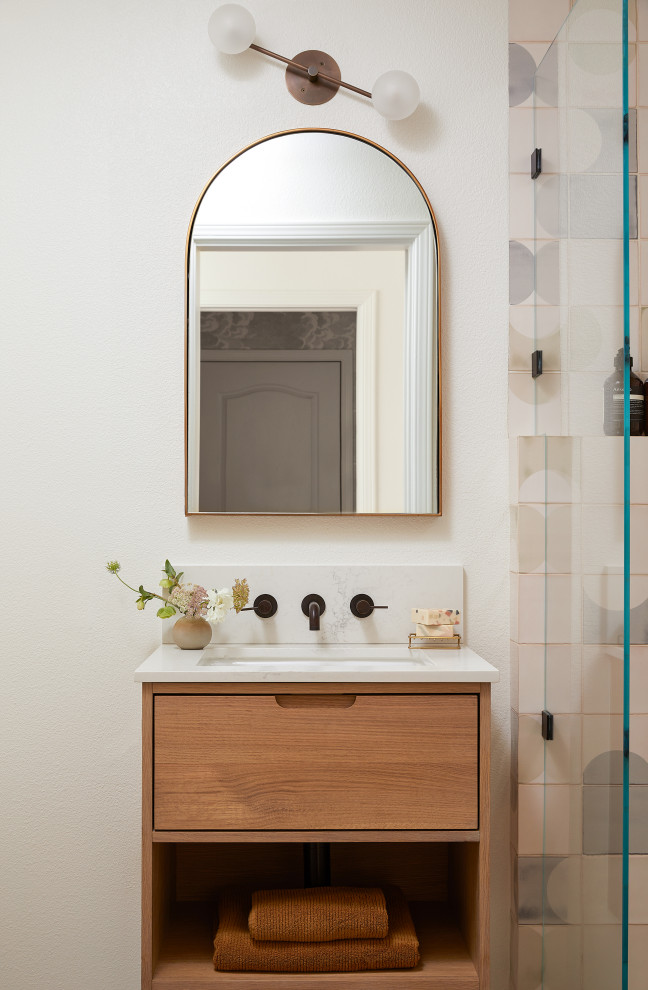 This is an example of a small contemporary bathroom in San Francisco with flat-panel cabinets, light wood cabinets, an alcove shower, a two-piece toilet, blue tile, ceramic tile, white walls, limestone floors, an undermount sink, engineered quartz benchtops, grey floor, a hinged shower door, white benchtops, a single vanity and a floating vanity.