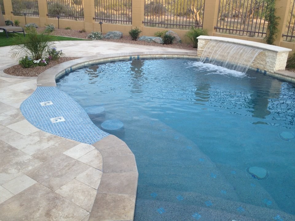 Example of a large backyard tile and kidney-shaped lap pool fountain design in Phoenix