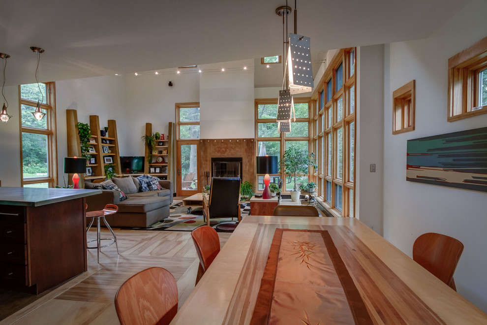 This is an example of a contemporary open plan dining in Minneapolis with plywood floors.