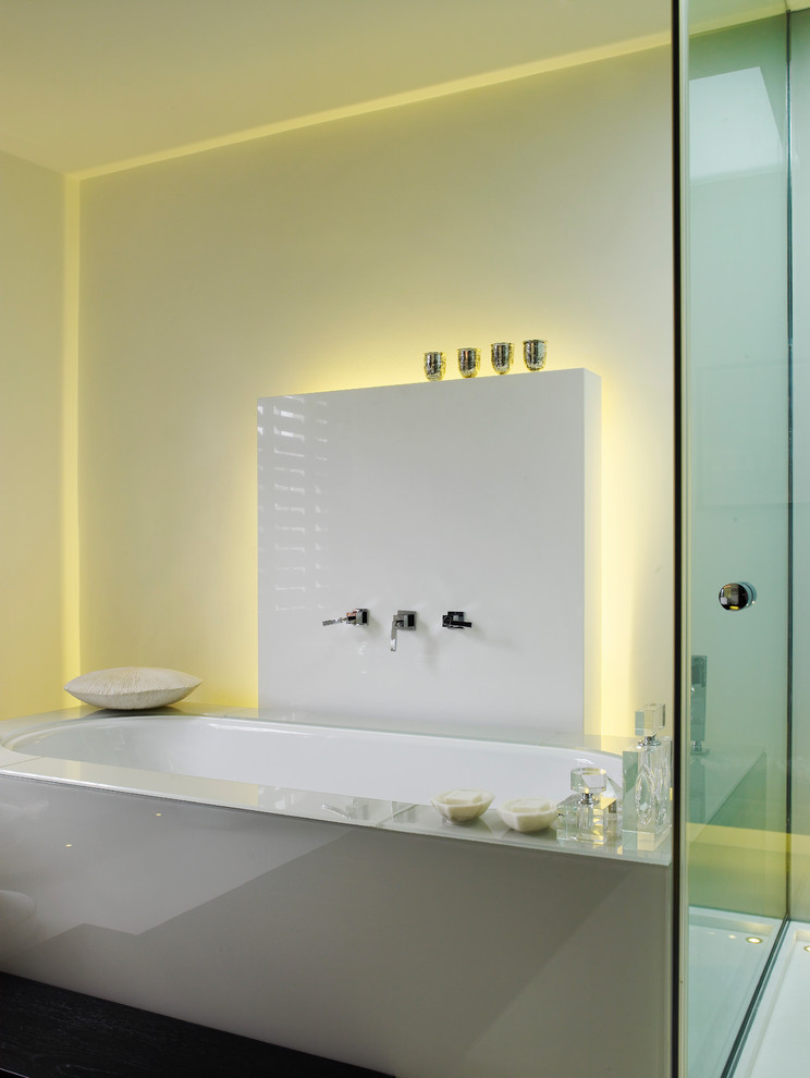 This is an example of a contemporary bathroom in London with an alcove tub.