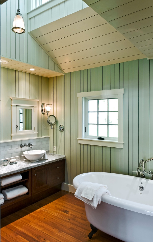 Photo of a beach style master bathroom in Portland Maine with a vessel sink, dark wood cabinets, a freestanding tub, gray tile, subway tile, green walls and medium hardwood floors.
