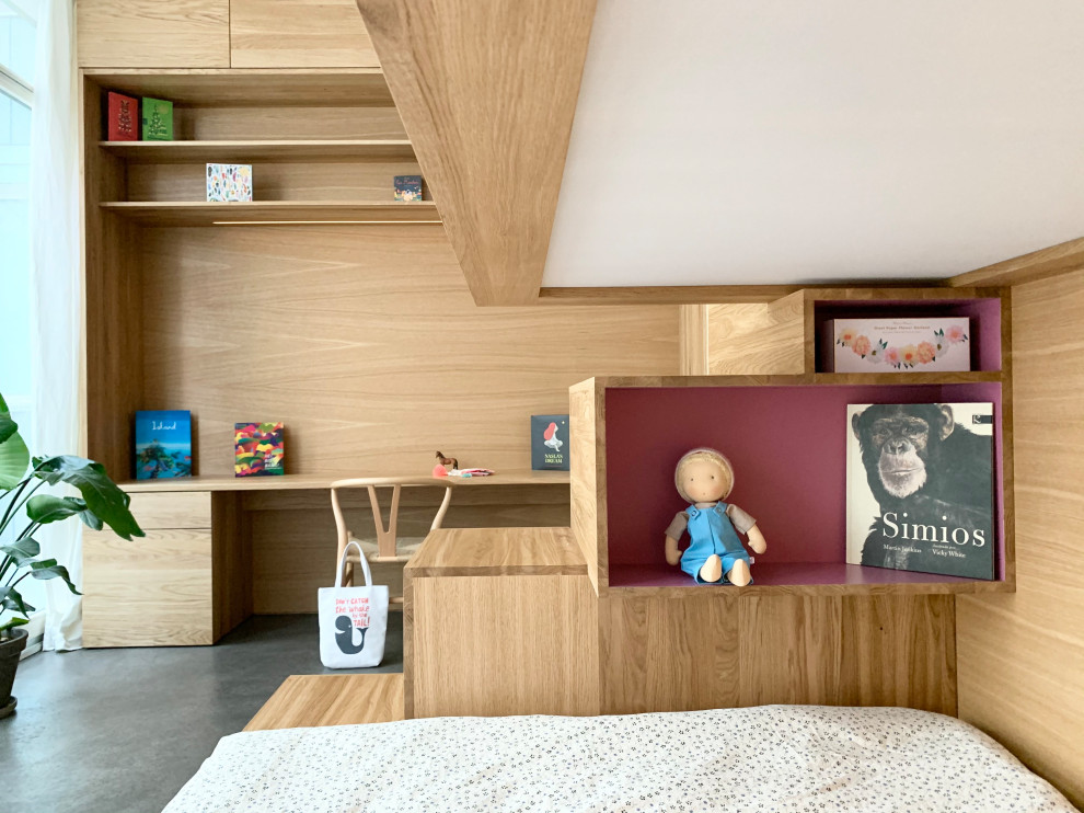 This is an example of a small contemporary kids' study room for kids 4-10 years old and girls in Berlin with white walls, concrete floors, grey floor and wood walls.