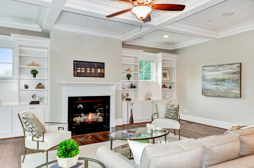 Inspiration for a mid-sized transitional formal open concept living room in DC Metro with grey walls, medium hardwood floors, a standard fireplace, a wood fireplace surround, no tv and brown floor.