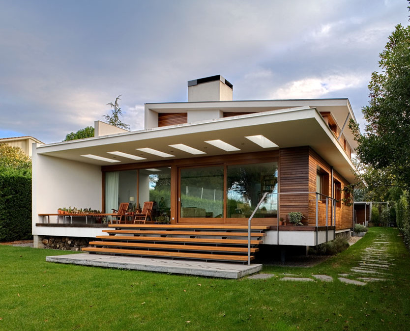 This is an example of a mid-sized contemporary two-storey brown exterior in Other with wood siding and a shed roof.