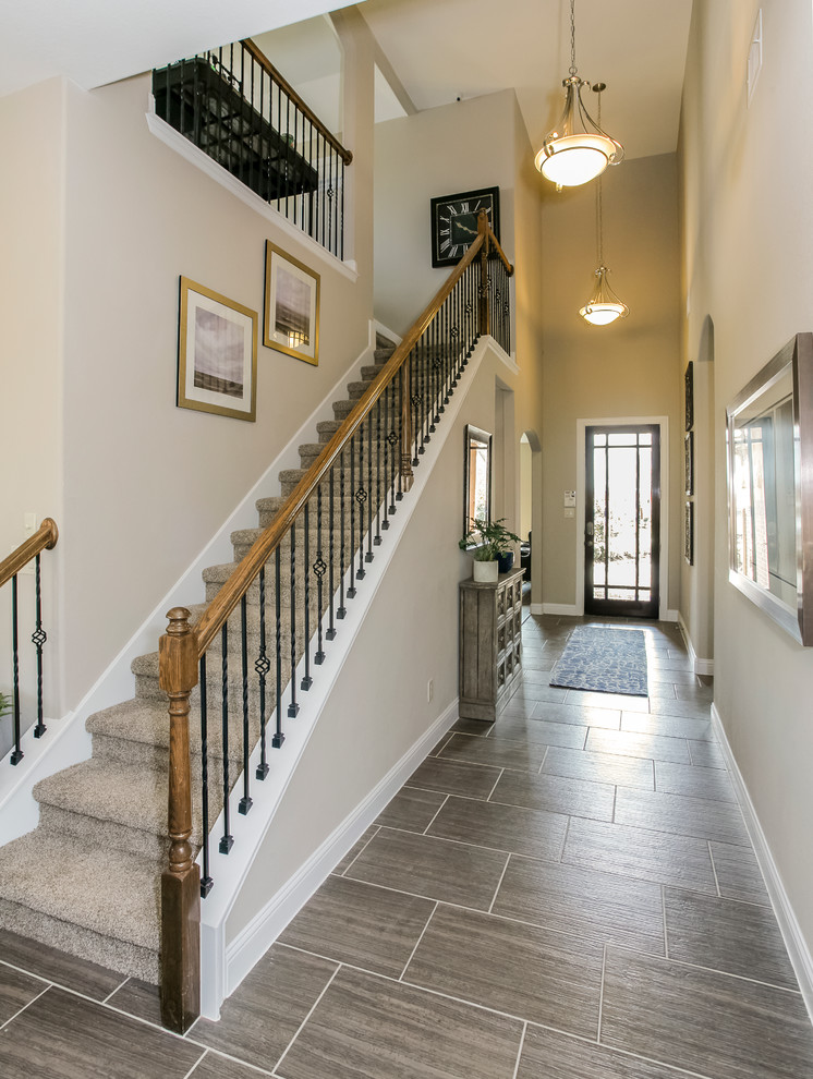 Inspiration for a large transitional carpeted straight staircase in Houston with carpet risers.