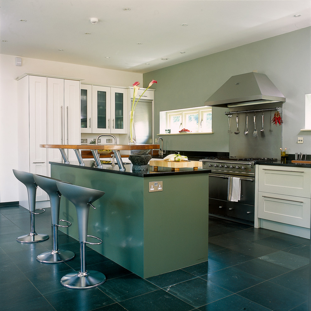 Photo of a contemporary kitchen in Berkshire with shaker cabinets, white cabinets and with island.