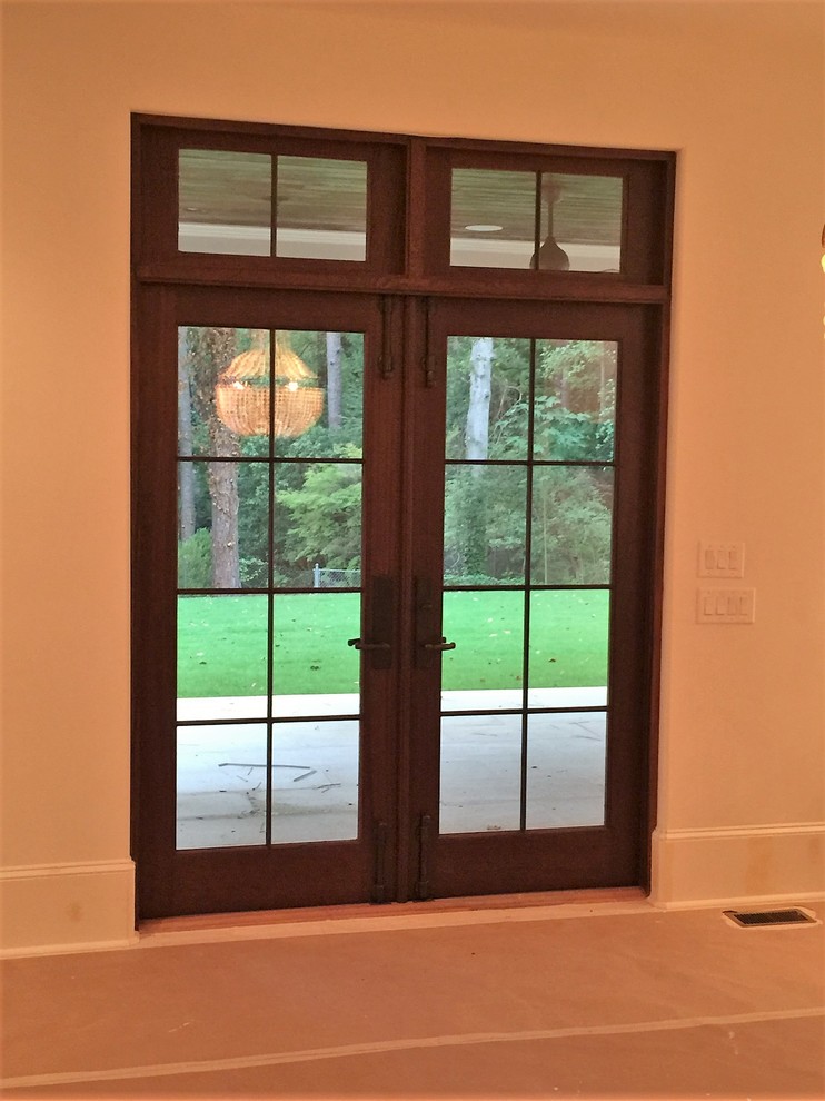 Photo of a mid-sized traditional entryway in Atlanta with white walls, a double front door and a medium wood front door.