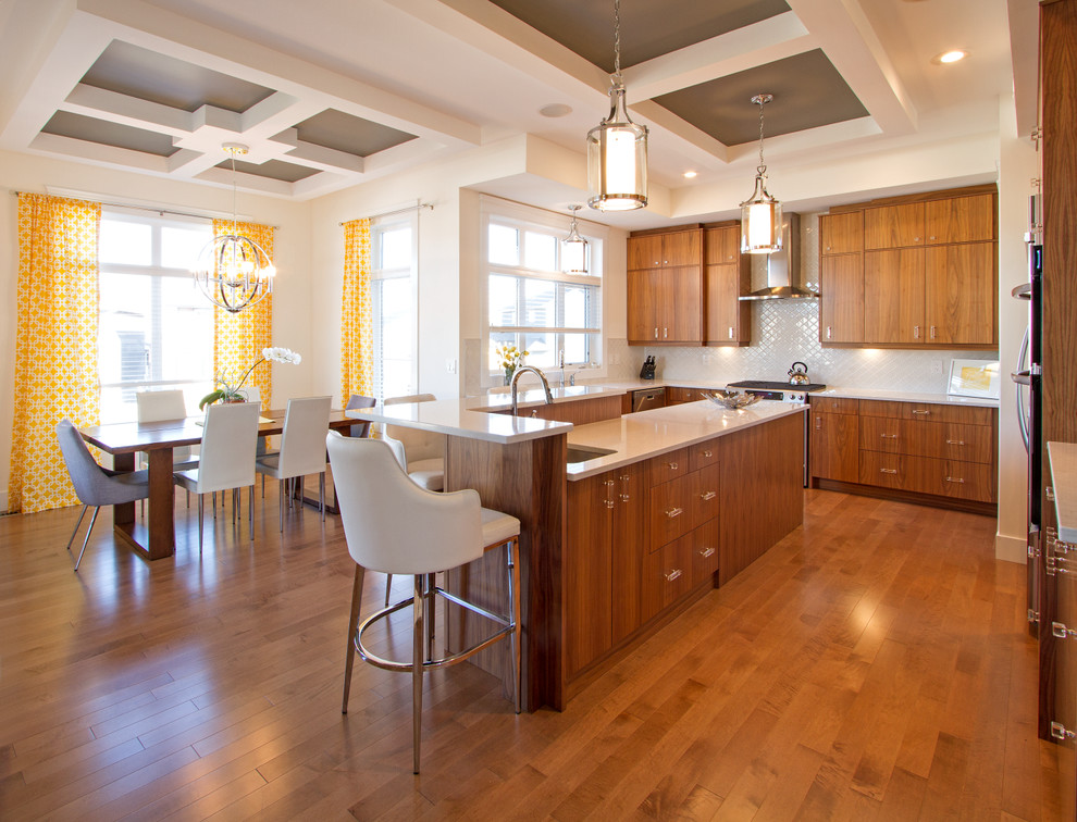 Inspiration for a large modern l-shaped medium tone wood floor eat-in kitchen remodel with an undermount sink, flat-panel cabinets, medium tone wood cabinets, quartz countertops, white backsplash, ceramic backsplash, stainless steel appliances and an island