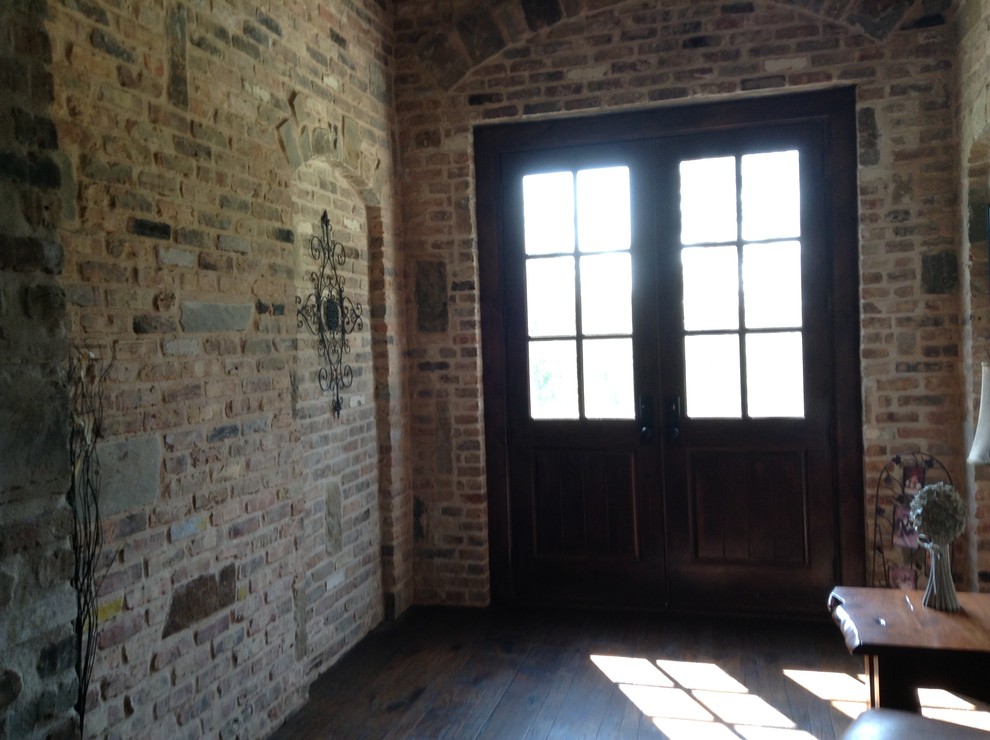 Inspiration for a mid-sized rustic dark wood floor entry hall remodel with red walls and a dark wood front door