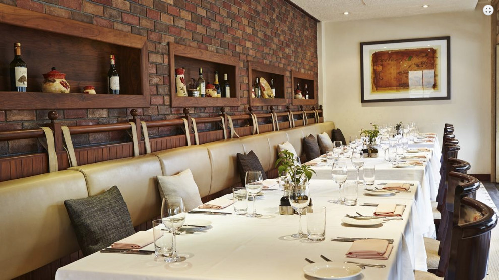 Dining room - rustic ceramic tile and brick wall dining room idea with white walls