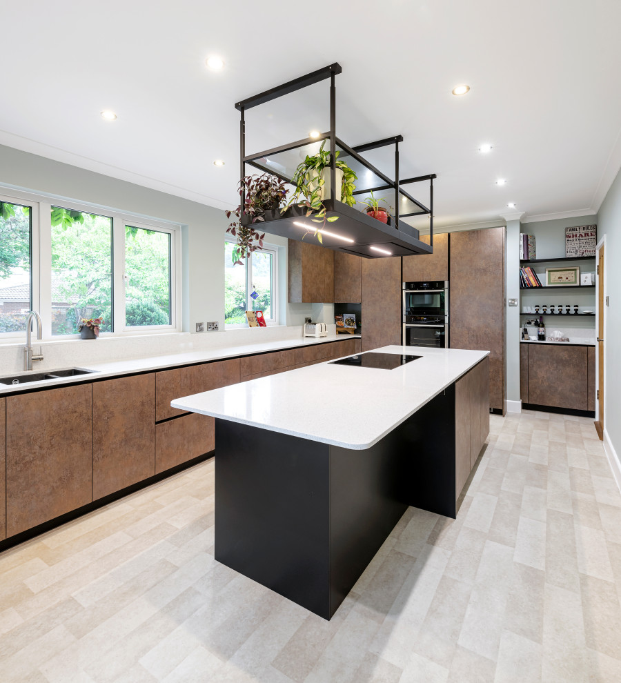 Mid-sized contemporary l-shaped eat-in kitchen in Other with flat-panel cabinets, quartzite benchtops, black appliances, ceramic floors, with island and white benchtop.