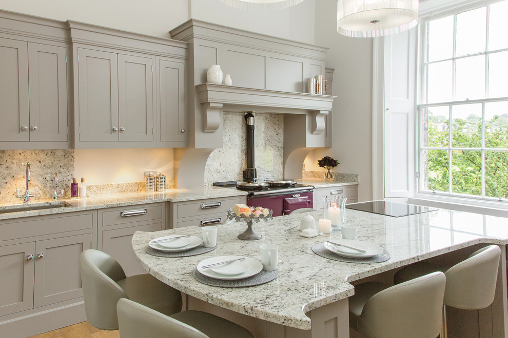 Mid-sized transitional eat-in kitchen in Edinburgh with an undermount sink, grey cabinets, marble benchtops, grey splashback, with island, beige floor and grey benchtop.