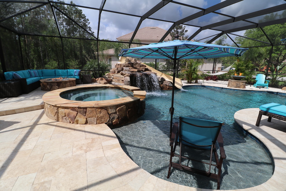 Example of a large transitional indoor concrete paver and custom-shaped water slide design in Tampa