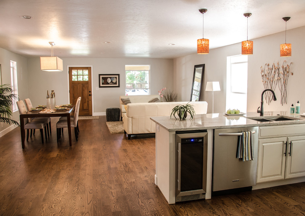 Inspiration for a mid-sized transitional u-shaped dark wood floor open concept kitchen remodel in Denver with white cabinets, granite countertops, beige backsplash, stainless steel appliances, an undermount sink, raised-panel cabinets and a peninsula