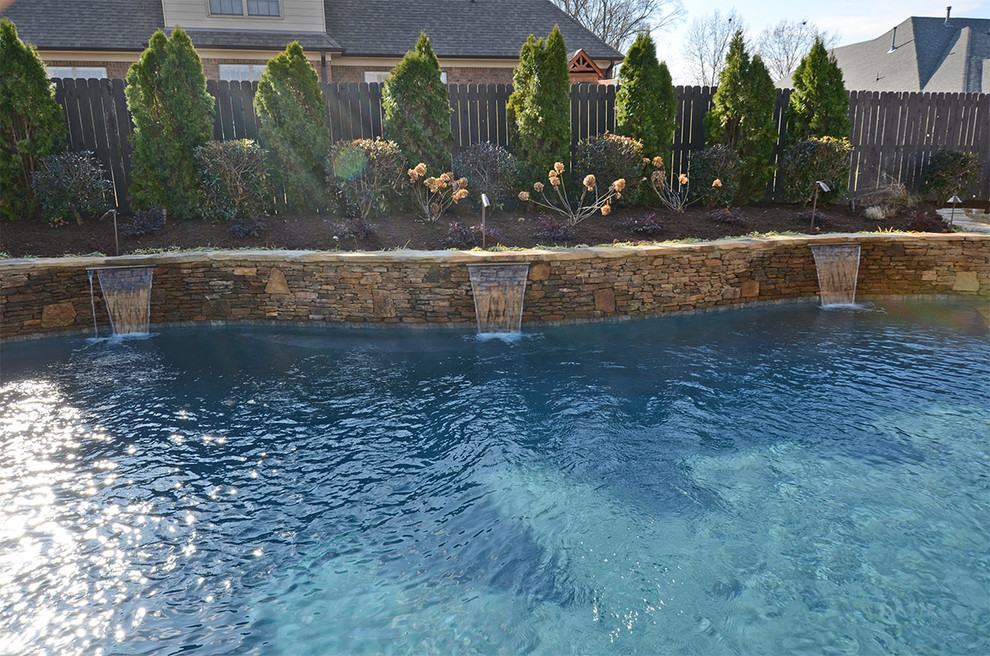 Inspiration for a large southwestern backyard concrete and custom-shaped lap pool fountain remodel