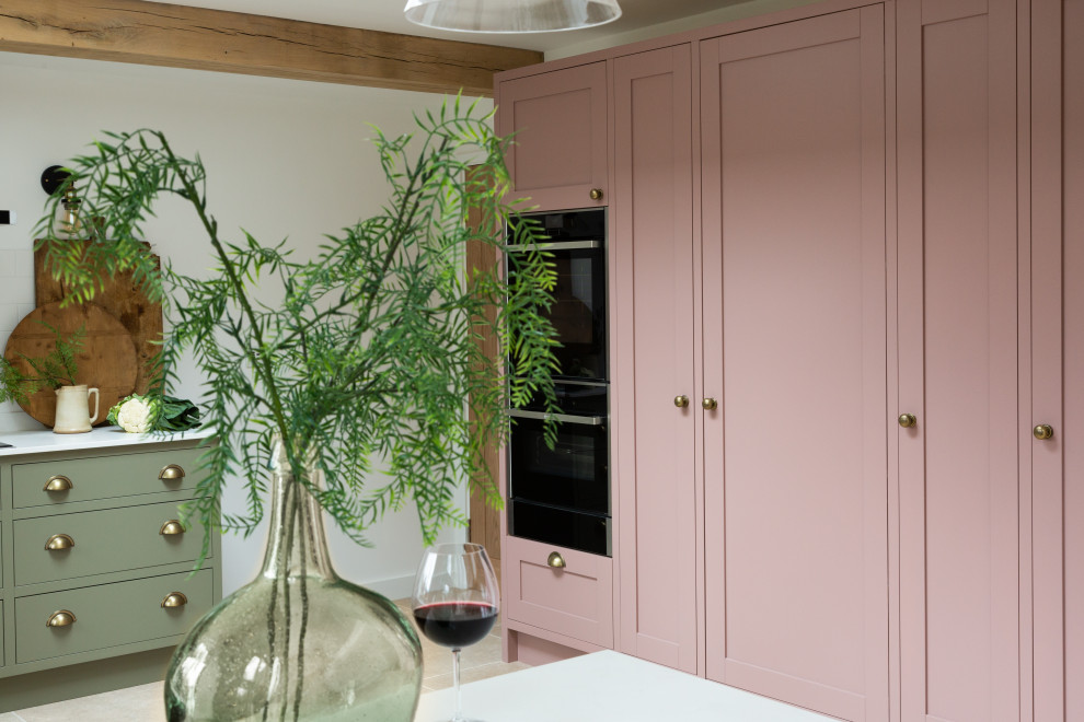 Large contemporary l-shaped eat-in kitchen in Kent with shaker cabinets, pink cabinets, quartzite benchtops and white benchtop.