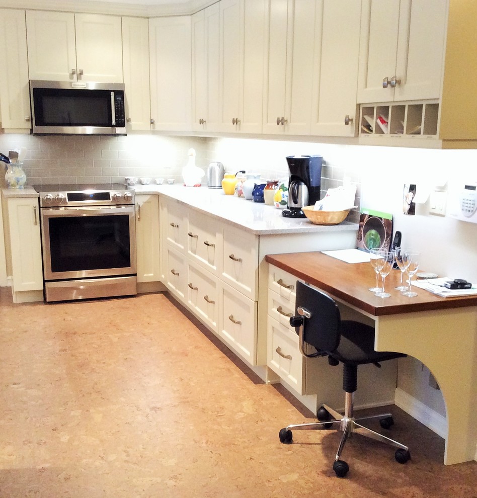 Example of a transitional cork floor kitchen design in Edmonton with white cabinets, quartzite countertops, gray backsplash, ceramic backsplash and stainless steel appliances