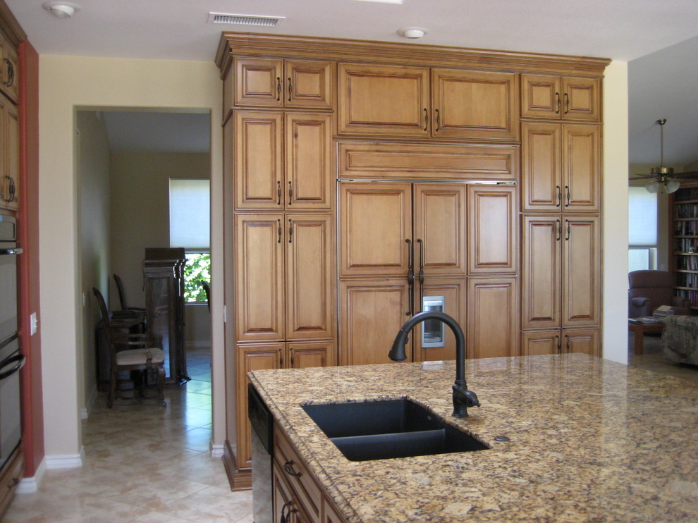 This is an example of a large traditional eat-in kitchen in Phoenix with raised-panel cabinets, light wood cabinets, granite benchtops and with island.