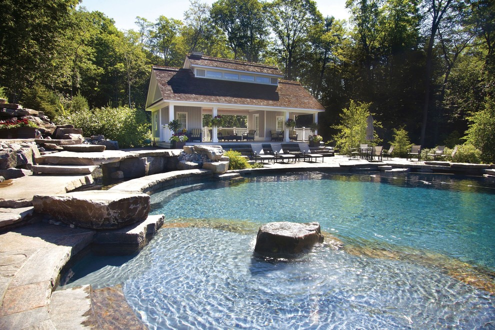 Pool house - large contemporary backyard stone and custom-shaped infinity pool house idea