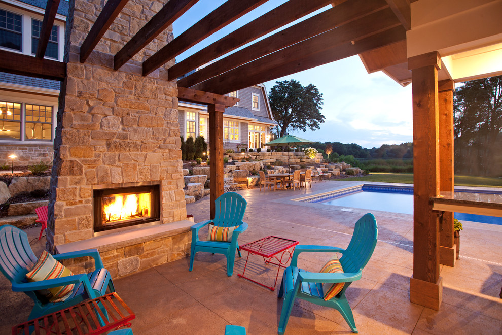 This is an example of a beach style patio in Minneapolis with a pergola and with fireplace.