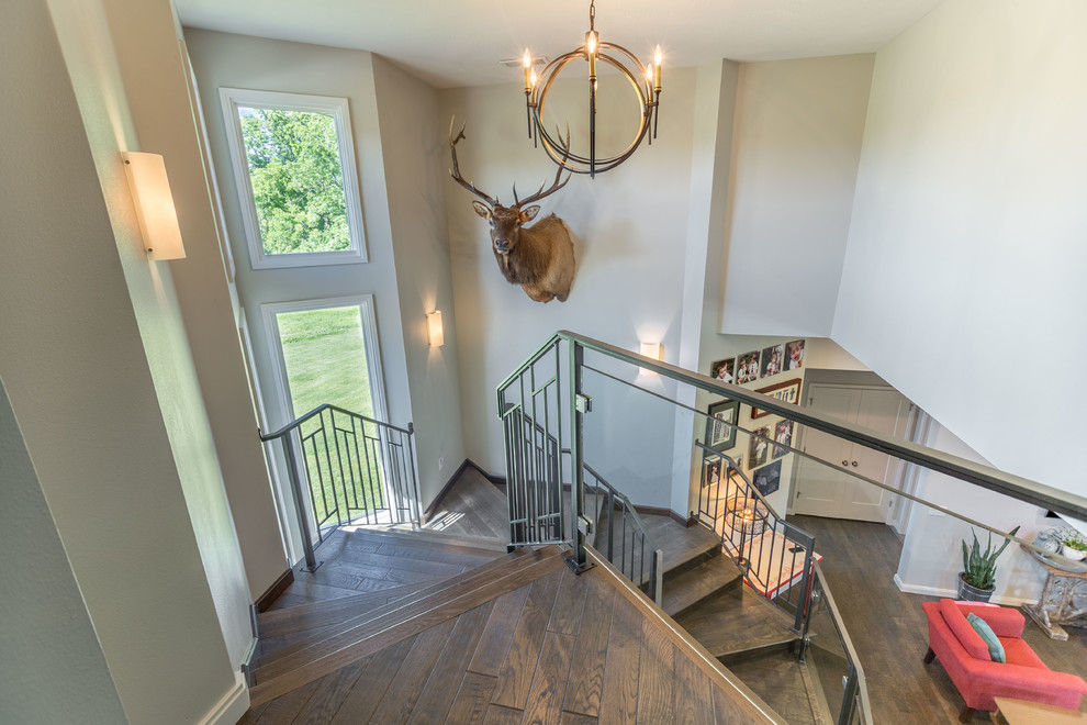 Example of a mid-sized trendy wooden u-shaped metal railing staircase design with wooden risers