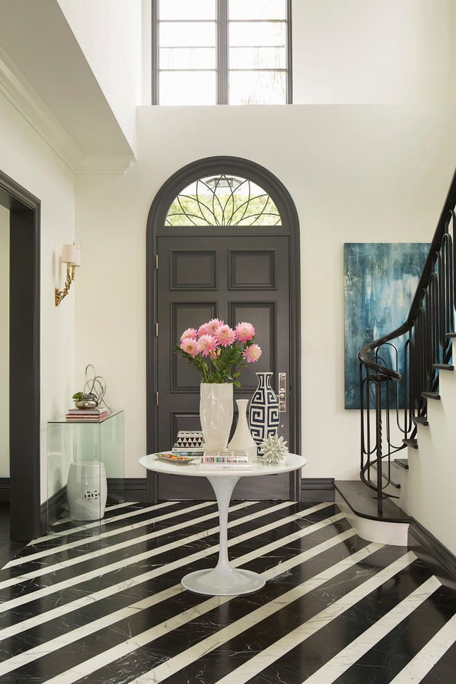 This is an example of a transitional foyer in Los Angeles with a single front door, a gray front door and multi-coloured floor.