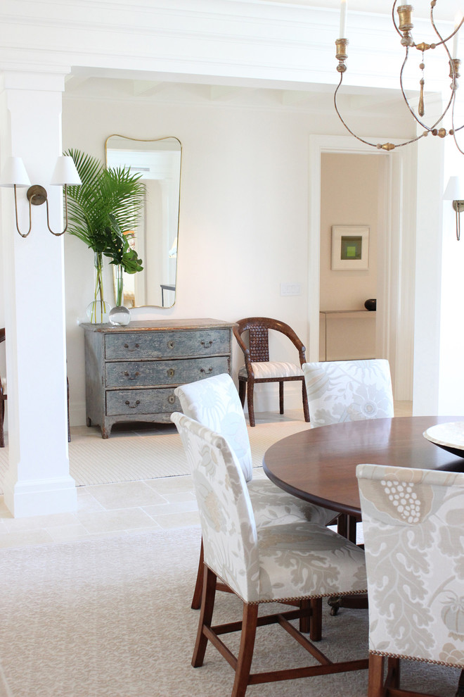 Photo of a scandinavian dining room in Miami with white walls, limestone floors and beige floor.