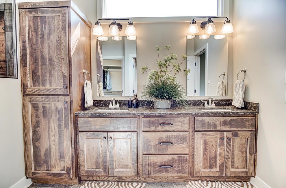 This is an example of a large country master bathroom in Other with recessed-panel cabinets, distressed cabinets, an open shower, multi-coloured tile, cement tile, beige walls, vinyl floors, a drop-in sink, quartzite benchtops, brown floor and an open shower.