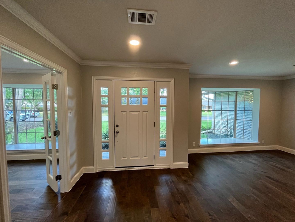 Inspiration for a large transitional dark wood floor and brown floor front door remodel in Dallas with gray walls and a white front door