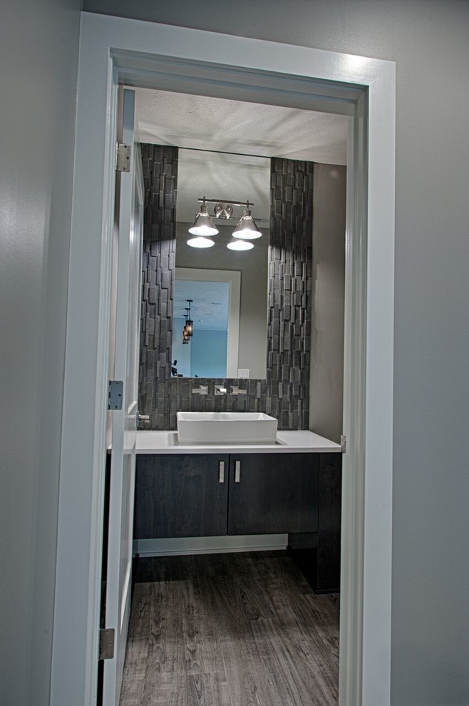 Inspiration for a transitional gray tile cement tile floor and gray floor home design remodel with shaker cabinets, white cabinets, a wall-mount sink, wood countertops and a hinged shower door