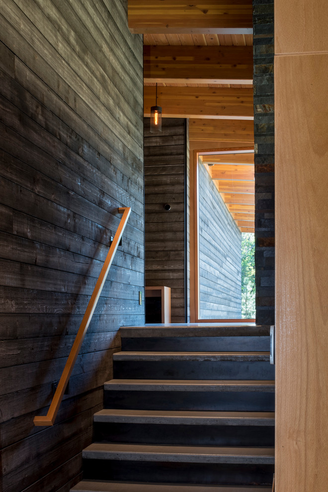 Inspiration for a mid-sized country wood straight staircase in Seattle with metal risers.