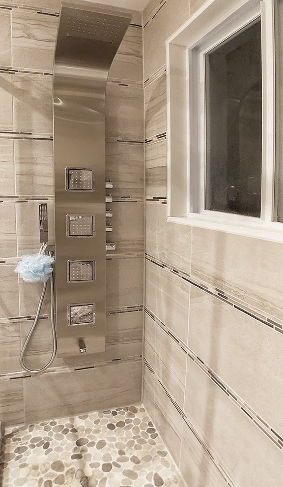 Mid-sized contemporary master bathroom in Montreal with flat-panel cabinets, medium wood cabinets, an alcove shower, a one-piece toilet, beige tile, ceramic tile, beige walls, ceramic floors, a vessel sink, engineered quartz benchtops, brown floor and a sliding shower screen.