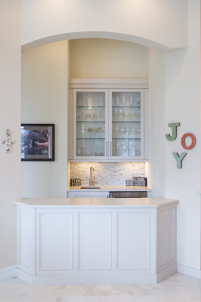 Large transitional u-shaped porcelain tile and beige floor enclosed kitchen photo in Miami with an undermount sink, beaded inset cabinets, white cabinets, quartzite countertops, blue backsplash, subway tile backsplash, stainless steel appliances and an island