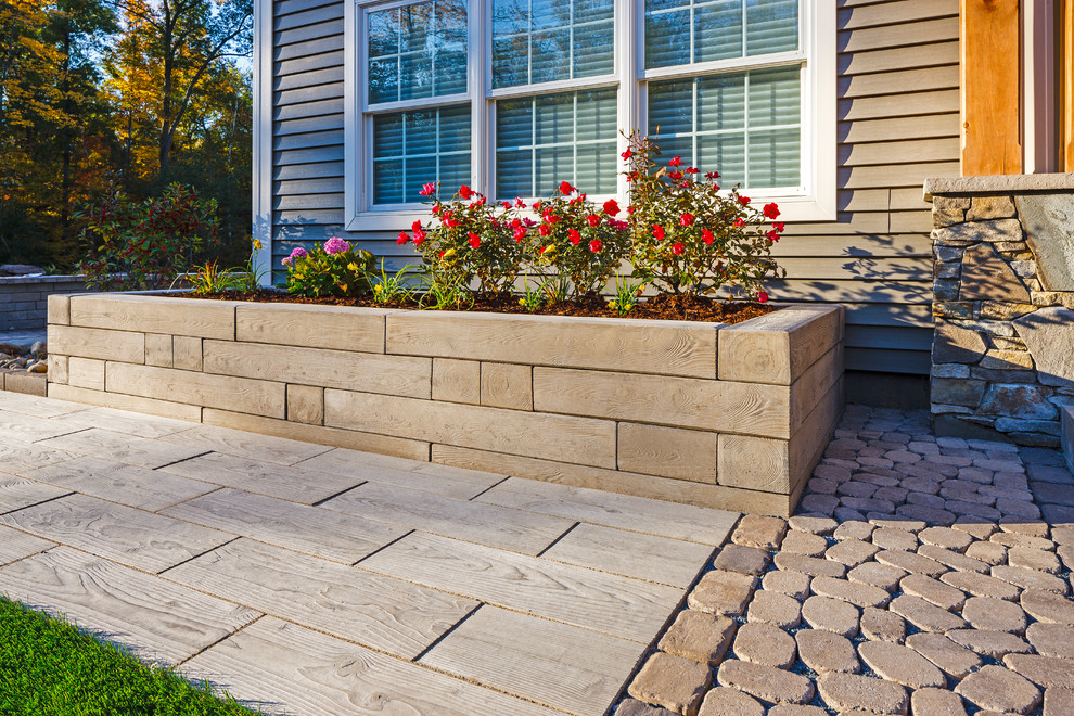 This is an example of a mid-sized rustic front yard retaining wall landscape.
