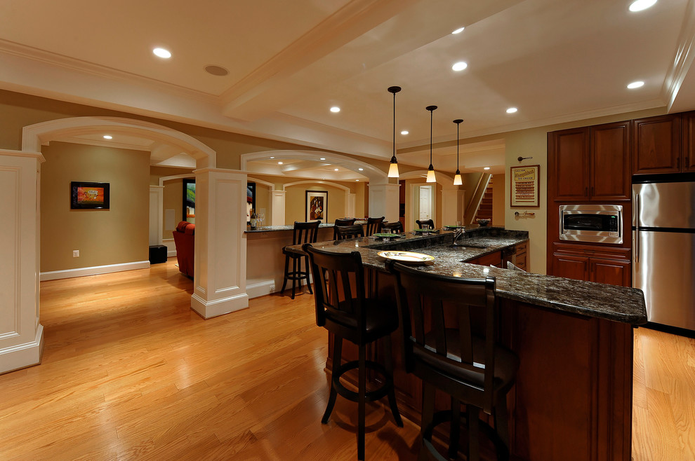 This is an example of a contemporary basement in DC Metro with medium hardwood floors.