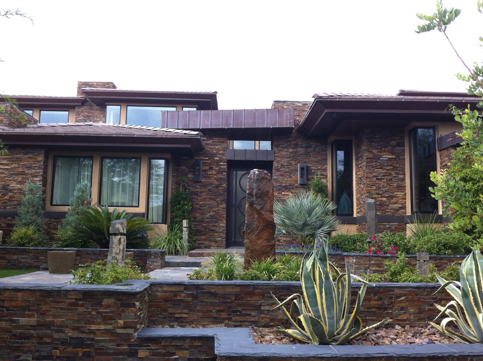 This is an example of a contemporary exterior in Las Vegas with stone veneer.