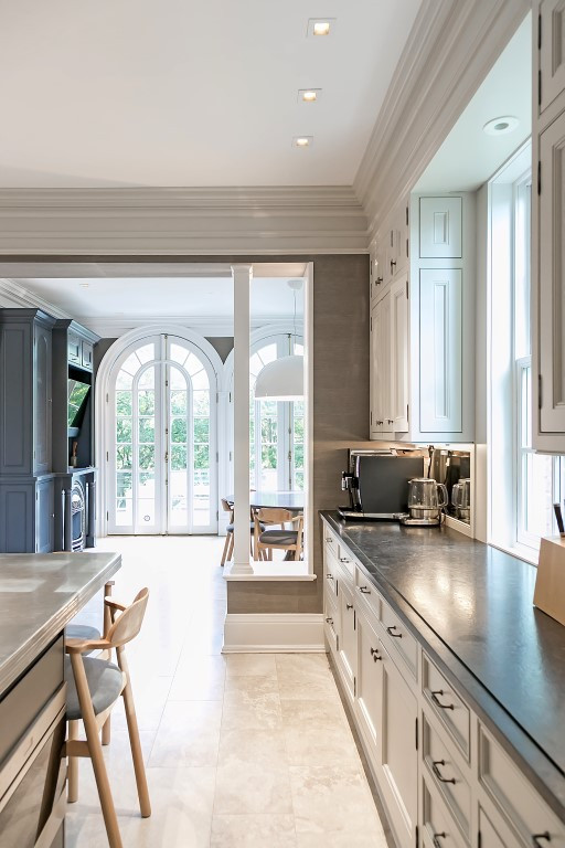 Eat-in kitchen - huge transitional u-shaped marble floor and beige floor eat-in kitchen idea in Toronto with an undermount sink, raised-panel cabinets, gray cabinets, soapstone countertops, gray backsplash, marble backsplash, stainless steel appliances, an island and black countertops